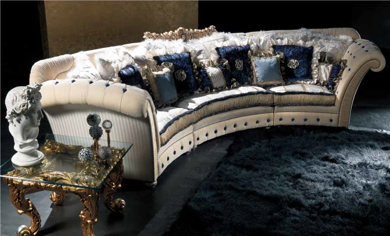 Curved cream sofa with tufted back and blue scatter cushions, luxury Italian furniture in London